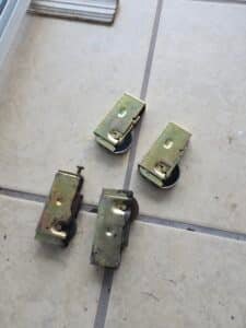 "Worn out rusted sliding door rollers replaced with new stainless steel wheels in Ocala FL"